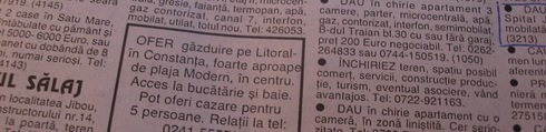 Browsing the ads in the newspaper