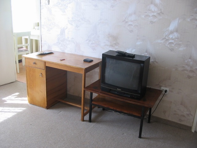 View of the TV table with the TV on it